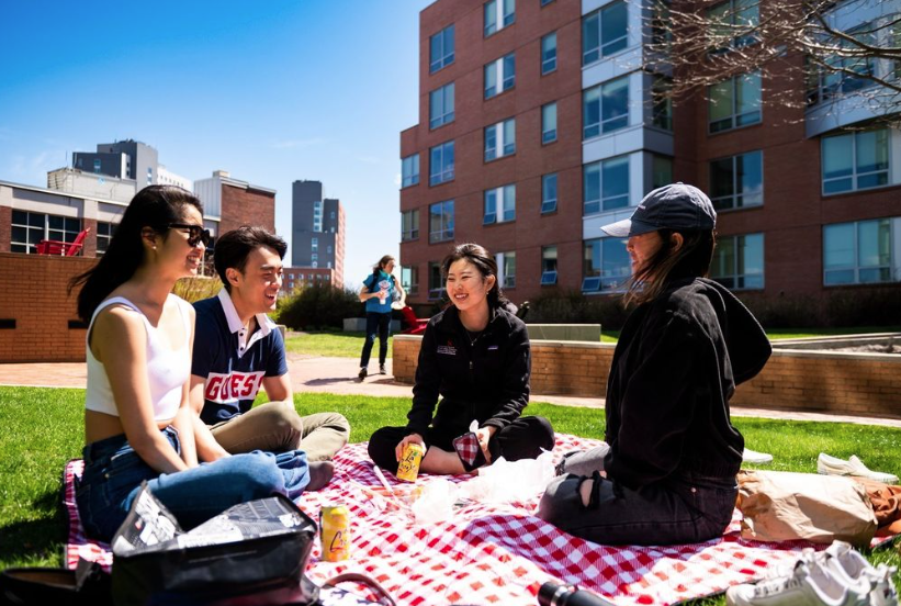 students sitting outside on campus